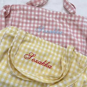 Detail of pink and yellow plaid canvas tote bags with high-quality Sozakka embroidery