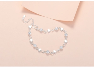 Detailed shot of silver planet bracelet with matte beads and glossy star charms