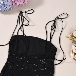Close-up of black lace patchwork and fine texture of the stretch camisole dress
