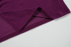 Detail shot of heavy-knit fabric with durable overlock stitching on a purple dress