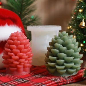 Detailed view of pinecone candle molds and finished wax creations in a festive setting