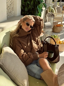 Brown oversized turtleneck cable knit sweater styled with light blue denim shorts