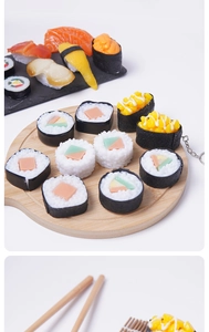 Macro detail of realistic PVC sushi keychain featuring salmon and egg texture