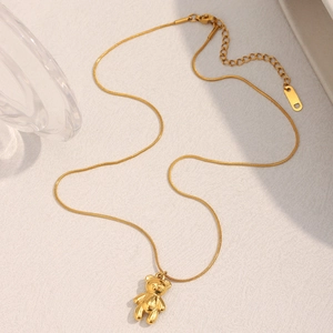 Detail of 18K gold plated stainless steel teddy bear pendant on a slim snake chain