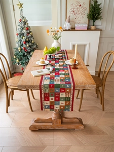 Detailed Christmas table runner with festive snowman and reindeer patchwork patterns