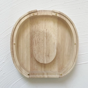 Top view of oval oak jewelry box with transparent glass lid and golden brass screws