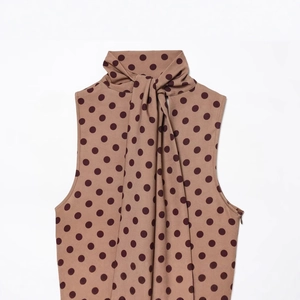 Brown polka dot halter top with high neck bow tie design for a vintage stylish look