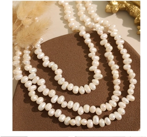 Close-up of elegant cream freshwater baroque pearl necklace with high-end texture
