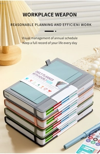 Detail view of multi-color leather daily planners with elastic closures and pen loops
