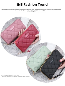 Detail view of colorful long wallets featuring quilted heart patterns and wrist straps