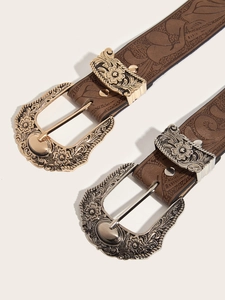Close-up of vintage floral embossed metal buckles and textured brown leather belts
