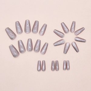 Detail of long coffin press on nails with silver marble texture and cat eye effect