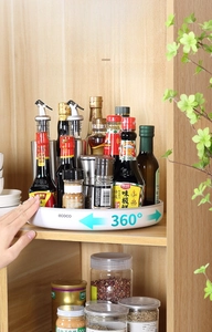 Close-up of a white 360-degree rotating spice rack tray in a kitchen cabinet