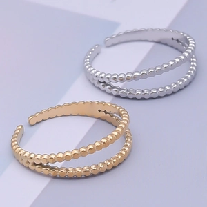 Detail of adjustable double-layered beaded ring in gold and silver finish 304 steel