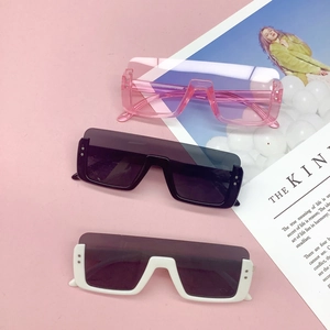 Three pairs of trendy square flat top children's sunglasses in pink, black, and white colors