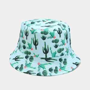 Detail of light blue bucket hat with cactus patterns and pink flowers in macro view