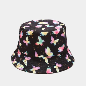 Detail of black bucket hat featuring colorful butterfly patterns and musical note accents