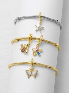 Detail view of 18k gold plated snake chain bracelets with bee and butterfly charms