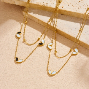 Dual-layer gold-plated stainless steel necklace with black and white heart pendants