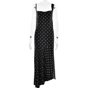 Detailed view of black polka dot slip dress with irregular hem and sleeveless design