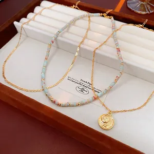 Three-piece layered ethnic beaded necklace set with a vintage sun relief gold coin pendant