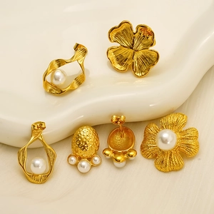 Vintage 18k gold plated flower stud earrings with elegant pearls on a pedestal