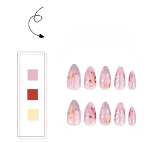 Detail of pink and purple press-on nails with gold plant patterns and star designs