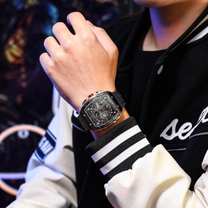 Close-up of stylish men's chronograph watch with black strap and rose gold metal accents