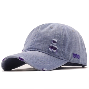 Vintage light blue denim baseball cap with purple distressed holes and 1999 embroidery