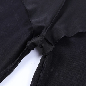 Close-up of black mesh fabric showing high-density grid pattern and reinforced stitching