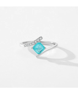 Macro detail of S925 silver ring featuring square blue gemstone and side diamonds