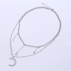 Minimalist layered necklace featuring silver moon, star pendants, and faux pearl details
