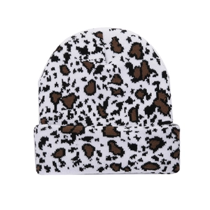 Detailed close-up of a leopard print knitted beanie with warm white and black patterns