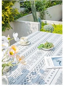 Macro detail of Bohemian geometric patterned linen tablecloth with fringe and woven texture