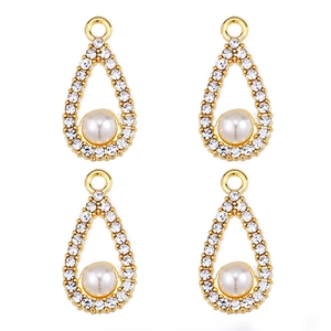 Macro shot of pearl and zircon alloy charms for DIY jewelry making in gold finish