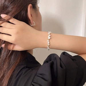 Baroque irregular pearl bracelet with gold beads on model wrist for minimalist style