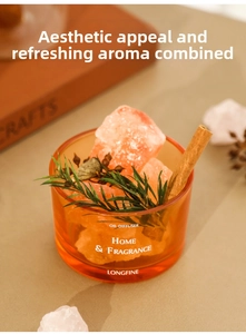 Macro shot of essential oil crystal diffuser with pink stones, cinnamon and green leaf