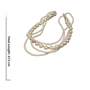 Macro detail of multi-layer baroque pearl necklace with gold cube beads and 47.5cm chain