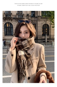 Street style view of a warm brown houndstooth scarf with elegant fringe and soft texture
