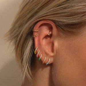 Close-up of S925 silver hoop earrings with colorful enamel drips and sparkling crystals
