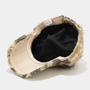 Inside view of camo faux fur baseball cap showing warm thick lining and cotton label