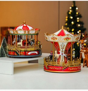Detailed view of luxury Christmas carousel music boxes with red and gold festive ornaments