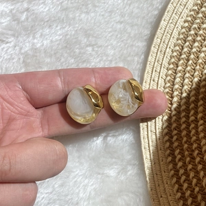 Chic gold-tone stainless steel earrings featuring marbled resin oval inlay for women