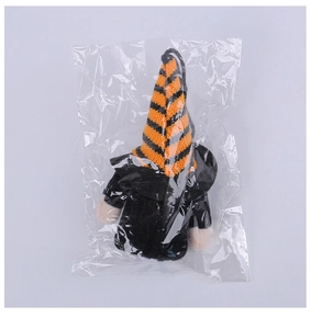 Detail of a black and orange striped knit hat for gnomes in transparent packaging