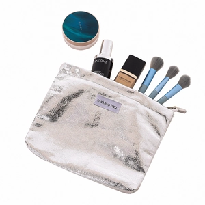 Silver metallic makeup bag with crackle texture showing brushes and cosmetics inside