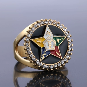 Macro detail of gold OES star ring with five-color enamel and sparkling crystals