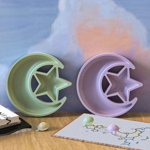 Star and moon shaped silicone storage trays in light green and purple pastel colors