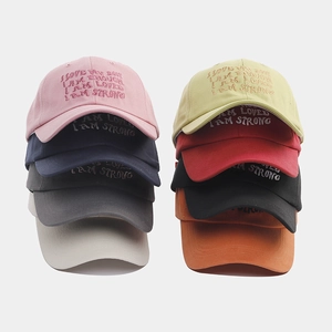 Detailed display of colorful cotton baseball caps with embroidered positive quotes