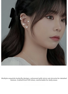 Close-up of model wearing s999 silver butterfly earrings set with cubic zirconia diamonds
