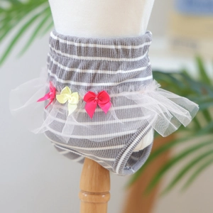 Detail view of dog physiological pants with striped knit fabric and white lace tutu skirt